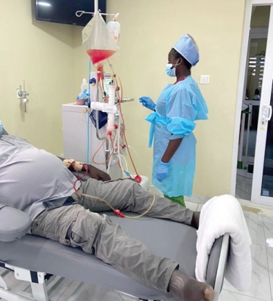  A staff member of Sage Medical Centre in Accra attending to a dialysis patient