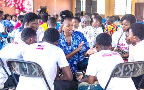 ­Rebecca Amo, a facilitator, mentoring a group of youth at the event