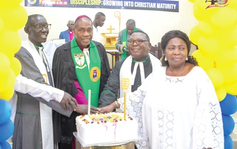 Right Rev. Dr Samuel Nii Nmai Ollennu (2nd from left), Methodis Bishop of Accra, being assisted by other ministers of the Methodist Church Ghana to cut the anniversary cake