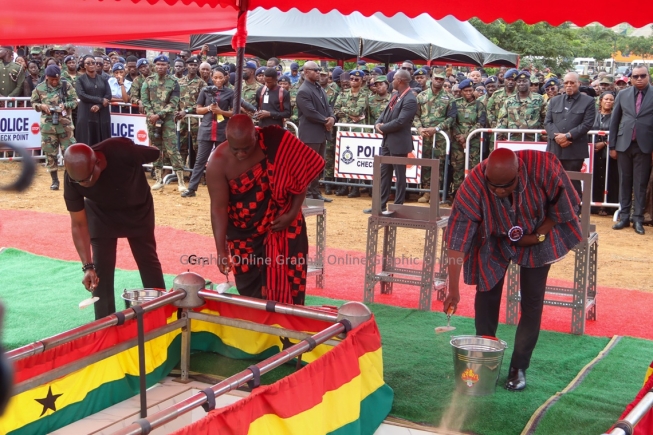 Families throwing sand on the caskets of the fallen patriots as part of the final rites during the burial ceremony. Pictures: ELVIS NII NOI DOWUONA