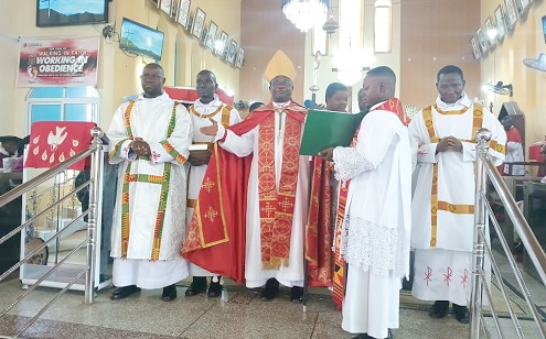 Rt. Rev. Felix Odei Annancy (middle), Bishop of the Koforidua Diocese  of the Anglican Church, interacting with the newly ordained priests 
