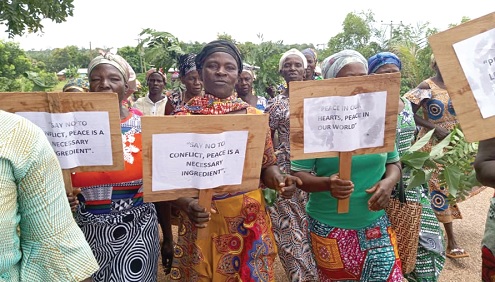 Women with their placards with messages about peace during the walk