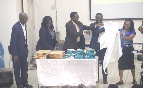 Prof. Samuel Kofi Afrane (middle), Vice-Chancellor, Christian Service University College, being assisted by Prof. David Asamoah (2nd from right), Pro-V.C., KNUST, to unveil a journal of the CSUC in Kumasi. Those with them include Rev. Mary Fosu (2nd from left), Head Pastor, Grace Baptist Church, Amakom. Picture: EMMANUEL BAAH