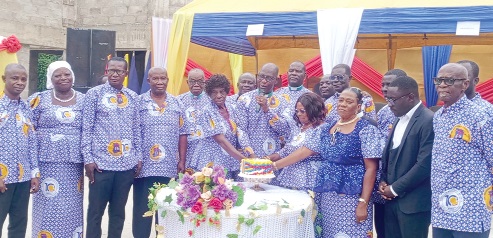 Very Rev. Isaac Aidoo (middle), Superintendent Minister of the Mankessim Circuit of the Methodist Church, cutting the anniversary cake with other dignitaries