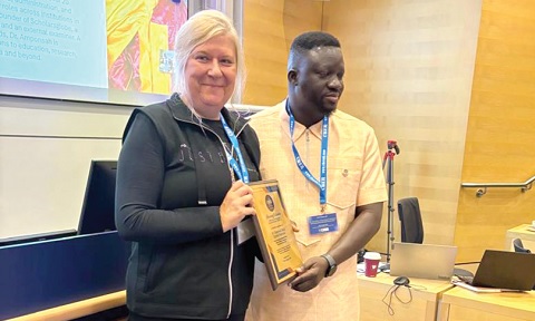 Dr Emmanuel Attah Kumah Amponsah (right), receiving his Honorary Fellowship of CBER from Prof. Malgorzata Magdalena