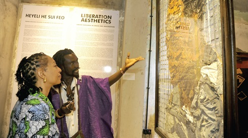 Nana Ananse pointing to one of his works displayed to Dr Samia Nkrumah, a daughter of the late first President