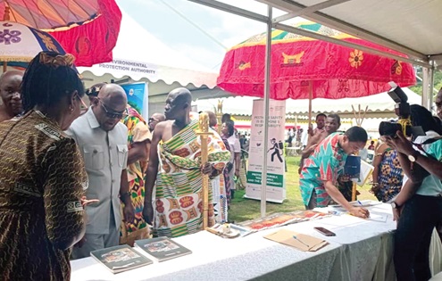 Ekow Panyin Edumoah Okyere (2nd from left), Central Regional Minister, at one of the exhibition stands