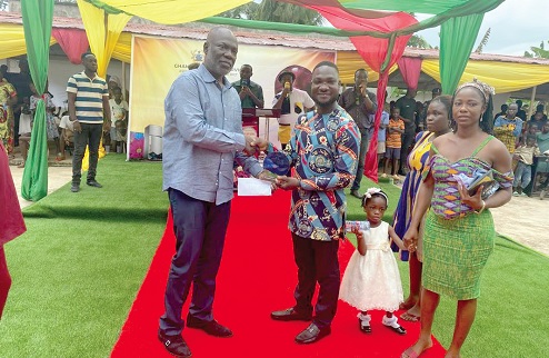 George Kwame Aboagye (left), MP for Asene-Akroso-Manso Constituency, presenting cash to Anthony Addo Nene, the father of Rashida Zaindo, the overall best BECE candidate for 2025 (private school category)