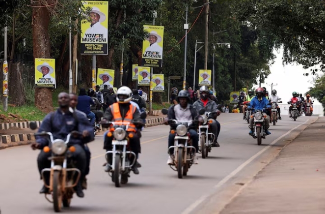 Motorcycle taxis ride past campaign posters of Uganda's President and leader of the ruling National Resistance Movement (NRM) party, Yoweri Museveni, ahead of the upcoming general election in Kampala, Uganda October 13, 2025. REUTERS/Miriam Watsemba/File Photo
