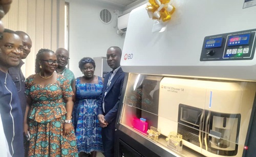 Prof. Dorothy Yeboah-Manu, Director of the NMIMR, inspecting the FACS Discover S8 Cell Sorter equipment after the commissioning.  On the left is Prof. Alfred Edwin Yawson, Provost of the College of Health Sciences, University of Ghana, and Prof. Kwadwo Ansah Koram (3rd from right), a former Director of NMIMR