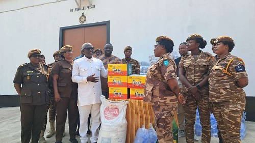Dr David Kofi Wuaku (in long sleeves) presenting the items to ADP Mandy Mensah (3rd from right), Officer-in-Charge of the Ho Female Prison