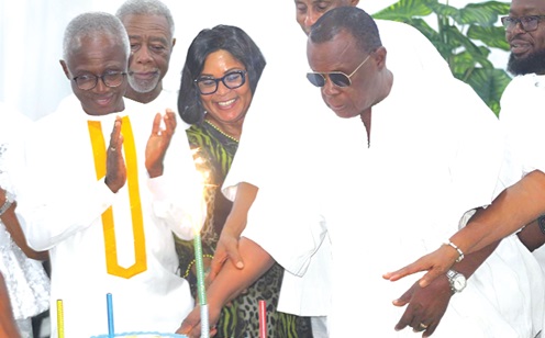  Dr Paul Kofi Fynn (right), Founder and Chancellor of the Wisconsin International University College (WIUC), Ghana, being assisted by Dr Lawrence Kanne (2nd from right), Vice-President WIUC, Faustina Elikplim Akurugu (3rd from right), MP for Dome Kwabenya, and other guests to cut the 85th birthday cake. Picture: ESTHER ADJORKOR ADJEI 