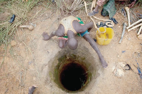 An artisanal gold miner looking into a small-scale mine 