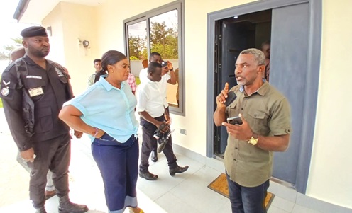 Godfred Nsiah Amoako (right), Head of Works at the Regional Coordinating Council, explaining issues to Rita Akosua Adjei Awatey, the Eastern Regional Minister, at the Residency