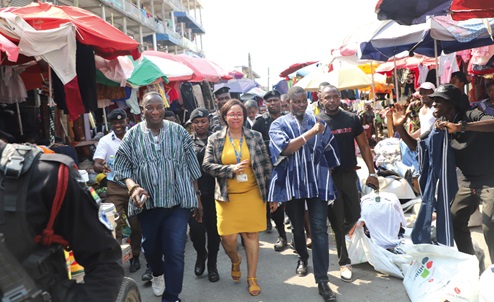 Linda Obenewaa Akweley Ocloo (2nd from left), Greater Accra Regional Minister; Alfred Kotey Ashie (right), MP for Odododiodioo Constituency, and Paul Oblie Laryea (left), NDC Constituency Chairman of Odododiodioo, responding to cheers from some traders during a visit to Kantamanto in Accra. Picture: EDNA SALVO KOTEY