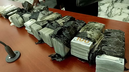 U.S. Dollar currency recovered from Cheng Chang-Fu, Wan Ling-Wu, and Cheng Hai-Yan, all Chinese citizens arrested in possession of gold bars and $400,000 in cash and found guilty of illegal activities linked to the artisanal mining sector, are displayed inside the courtroom in Bukavu, South Kivu Province of the Democratic Republic of the Congo January 4, 2025. REUTERS