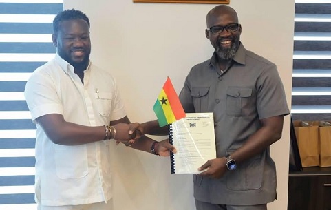 Afetsi Awoonor (left), Managing Director of BOST, receiving handing over notes from Dr Edwin Provencal, his predecessor