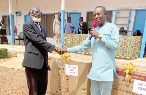  Dr Isaac Danso (right), Director, Centre for Scientific and Industrial Research , presenting an award to Joseph Akwandoh, a retiree 