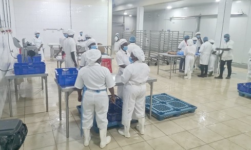  Workers processing chicken for the local market