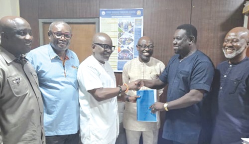 Akwasi Agyeman (middle) handing over to Otto Langmane, acting Chief Director, Ministry of Tourism, Arts and Culture. With them are some Directors of the Ministry and GTA