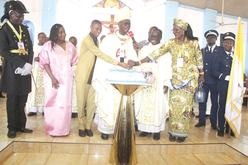 Most Reverend John Bonaventure Kwofie (4th from left ), the Metropolitan Archbishop of the Catholic Archdiocese of Accra, and Francis-Xavier Sosu (3rd from left), MP for Madina, cutting the 80th anniversary cake of St. Paul Catholic Church, Kpehe, Accra. With them are Mary Anna Alswell Ampah (3rd from right), Chairperson, St. Paul Catholic Church, Kpehe, and other priests. Picture: ESTHER ADJORKOR ADJEI 