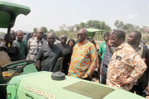 Eric Opoku (middle), Minister of Food and Agriculture, inspecting some tractors at the Agriculture Engineering Institute as others look on