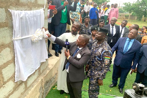 Pastor Dr Kwame Annor Boahen, President of the Mid-Ghana Union Conference of the SDA Church, cutting the tape to unveil the foundation stone plaque for the first Adventist Police Church in Ghana at the National Police Training School at Tesano in Accra