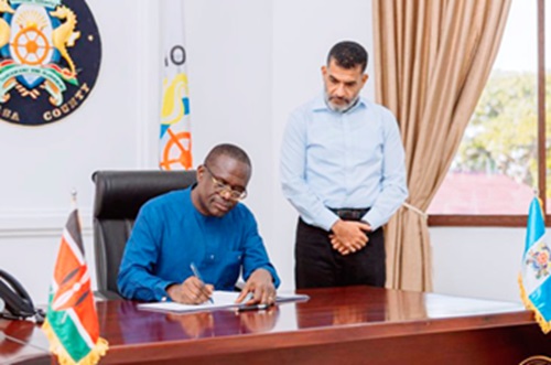Joseph Siaw Agyepong (left), Executive Chairman of Jospong Group, signing the partnership agreement while Abdullswamad Sherrif Nassir, the Governor of Mombasa County, looks on