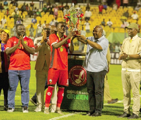 • President John Dramani Mahama (2nd from right) presenting the President's Cup trophy to Samba O’Neil, Kotoko’s captain, while Kofi Adams (right), Minister of Sports and Recreation, and Dr Frank Amoakohene (2nd from left), Ashanti Regional Minister, look on. Picture: Caleb Vanderpuye