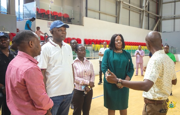 Kofi Adams (2nd from left), Minister of Sports and Recreation, being briefed during his visit to the Borteyman Sports Complex