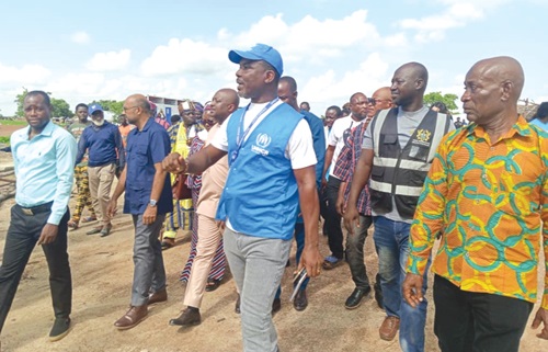 Samuel Dzikunu (in jacket), Head of Field Office of UNHCR, conducting the team from UNICEF and EU around the camp Samuel Dzikunu (in jacket), Head of Field Office of UNHCR, conducting the team from UNICEF and EU around the camp