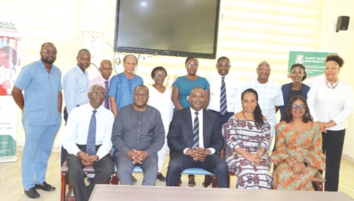 Professor Ahmed Jinapor (seated middle), Director-General of the Ghana Tertiary Education Commission, with management of the Family Health University