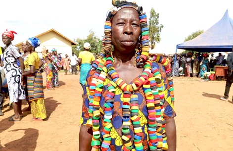 Abugri Ajabow, 50-year-old woman, adorned in a dress weaved from plastic bottle lids