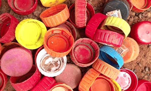 Some plastic bottle lids picked  by the woman for art