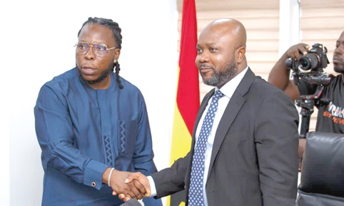 Divine Selase Agbeti (right), Director-General of the CSA, congratulating Dening Edem Hotor, the campaign’s brand ambassador, after the launch