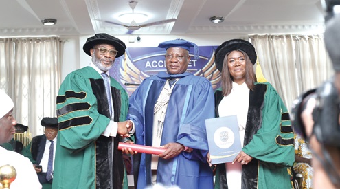 Drolor Bosso Adamtey I (left), Council Chairman of Accra Metropolitan University, conferring the honorary doctorate on COP Christian Tetteh Yohuno, IGP.  With them is Prof. Goski Alabi (right), acting Vice Chancellor, Accra Metropolitan University. Picture: BENEDICT OBOUBI
