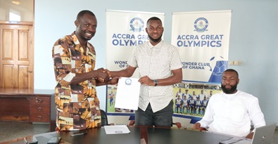 Coach Sulley Amadu and Eric Alagidede (left),  Olympics General Manager, show off the sealed two-year contract, flanked by the coach’s manager, Hamid Safiyanu Abubakar, during the official unveiling ceremony in Accra