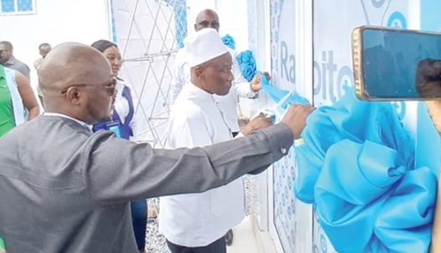 Naa Prof. Edmund Mwinyem Delle Chiir VIII (right), Founder of Rabito Clinics, who is also the Paramount Chief of the Nandom Traditional Area, being assisted by Banguu Delle, CEO, Rabito Clinics, to cut the ribbon