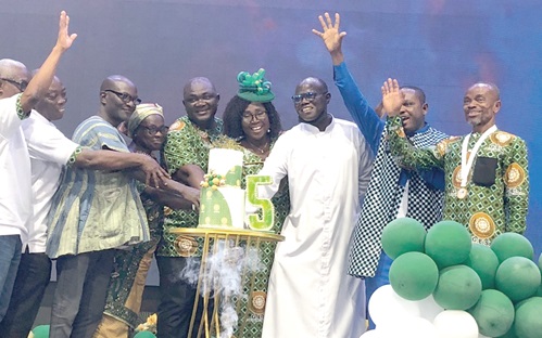 Rev. Fr Charles Ackon (3rd from right), Chairman for the event;  Monica Ansaba Kumahor (4th from right), Municipal Director of Education, and other dignitaries cutting the anniversary cake