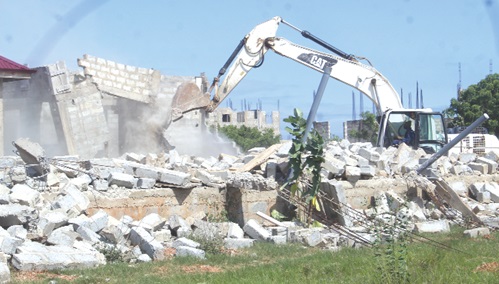 A structure being demolished at the site. Picture: ESTHER ADJORKOR ADJEI