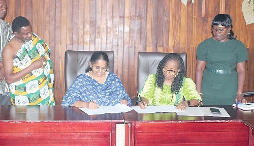 Prof. Marian D. Quain (seated right), Deputy Director General, CSIR, and Saalai Manikam (seated left), MD, Arima Farms Limited, signing the MoU. With them are Barima Acheampong Sarpong II (left), Director, Business Development, Arima Farms Limited, and Naomi Owusu Appiah (right), Director, Commercialisation, CSIR. Picture: ERNEST KODZI