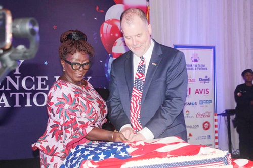 Dzifa Abla Gomashie (left), the Minister of Tourism, Culture and Creative Arts, and Rolf Olson, the Chargé d’Affaires at the US Embassy, cutting a cake decorated in a US flag to commemorate the US’ 249th Independence Day celebration