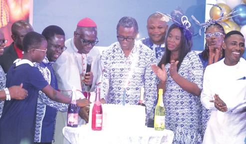 Right Rev. Michael Agyarkwa Bossman (3rd from left), the immediate past Administrative Bishop of the Methodist Church of Ghana, being assisted by Kobina Yeboah Okyere (2nd from left), the National Director of Compassion International Ghana; Reverend Philip Kofi Tutu (3rd from right), Chairman of the Governing Council of Compassion International Ghana, and other members of the organisation as they cut the anniversary cake. Picture: ESTHER ADJORKOR ADJEI