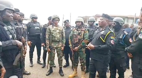 COP Christian Tetteh Yohuno (right), the Inspector General of Police, interacting with some officers during the visit to Asawase