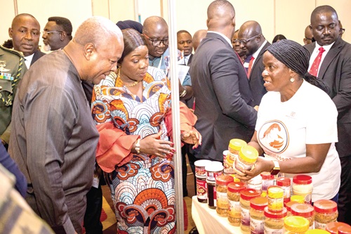 President John Mahama (left), Elizabeth Ofosu-Adjare (middle), Minister of Trade, Agribusiness, and Industry, inspecting a locally made fish powder exhibited during the National Agribusiness Dialogue. Picture: ELVIS NII NOI DOWUONA 