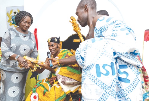 Prof. Naana Jane Opoku-Agyemang, Vice-President  (left), receiving a gift from Okatakyi Komeh VIII ((middle), Paramount Chief of Komenda 