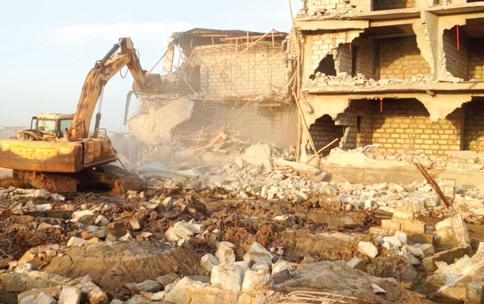 Onauthorised structures being demolished at the Ramsar site