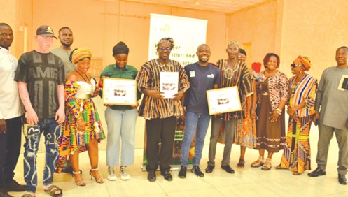 Some officials of GAYO present at the event displaying copies of the launched Period Health Empowerment Guide