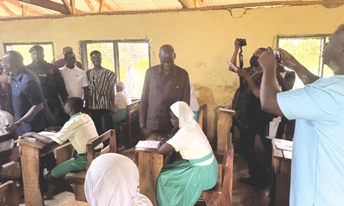 Haruna Iddrisu, Education Minister, observing a candidate writing the exams at the Techiman SHS examination centre