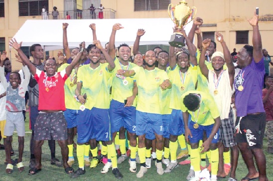 Players and supporters of Community 2 Sakasaka celebrating with the winner's trophy